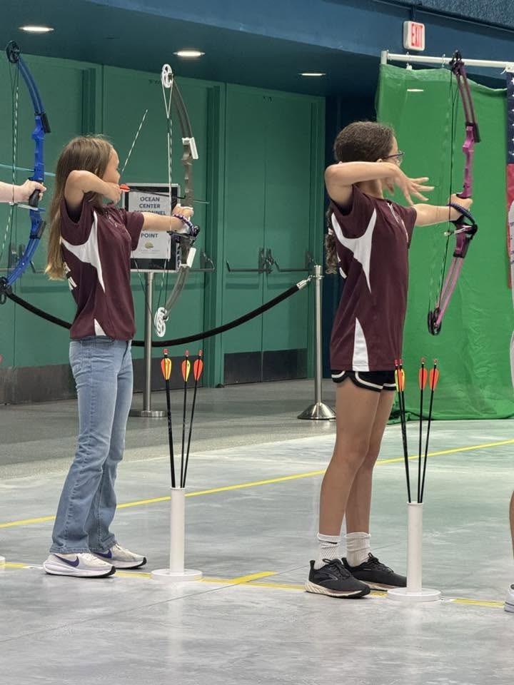 Alderson Archery team members at full draw during the 2026 NASP Championship