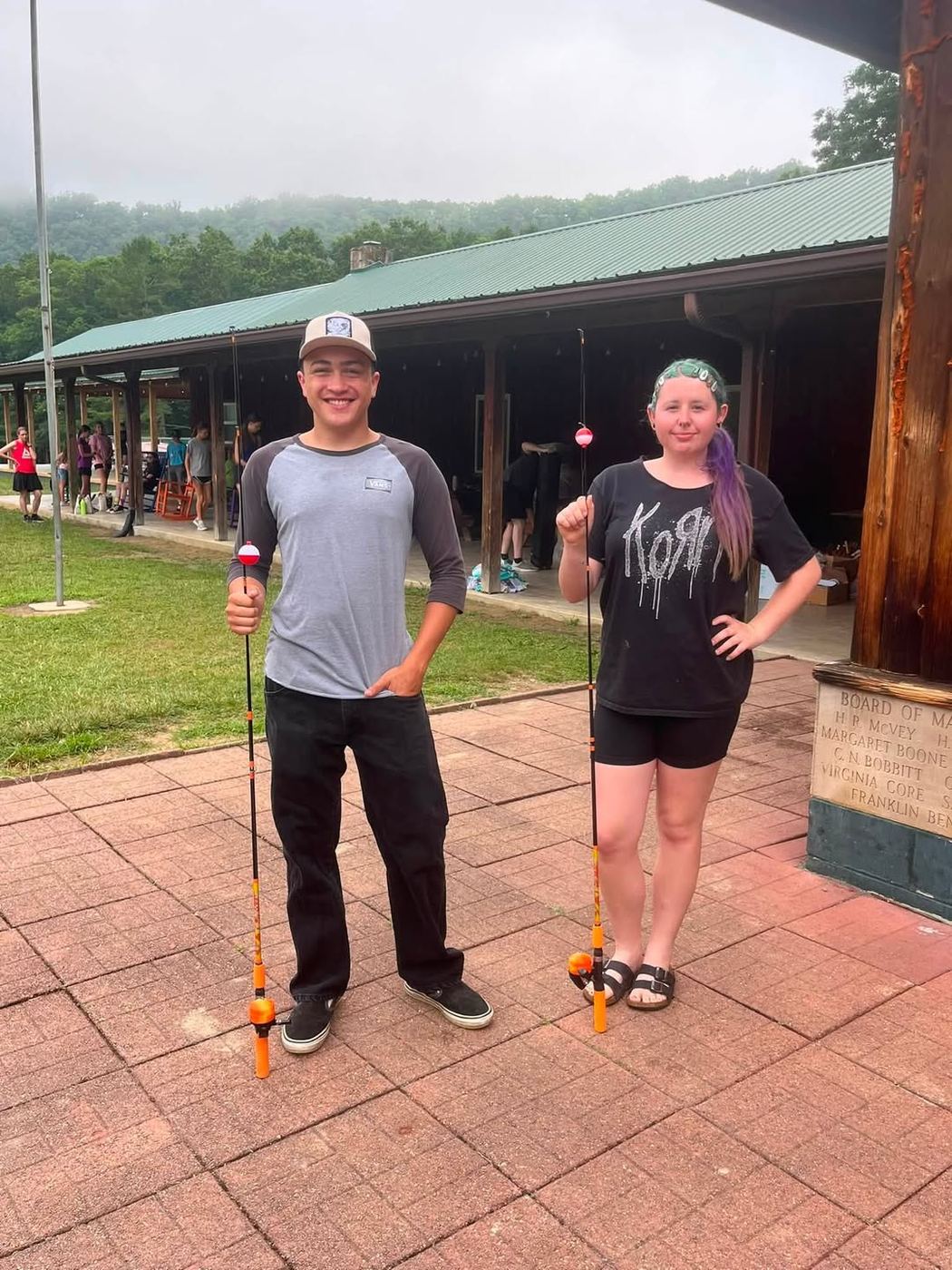 Two GVSA volunteers holding fishing poles supplied for Greenbrier Scout Day Camp