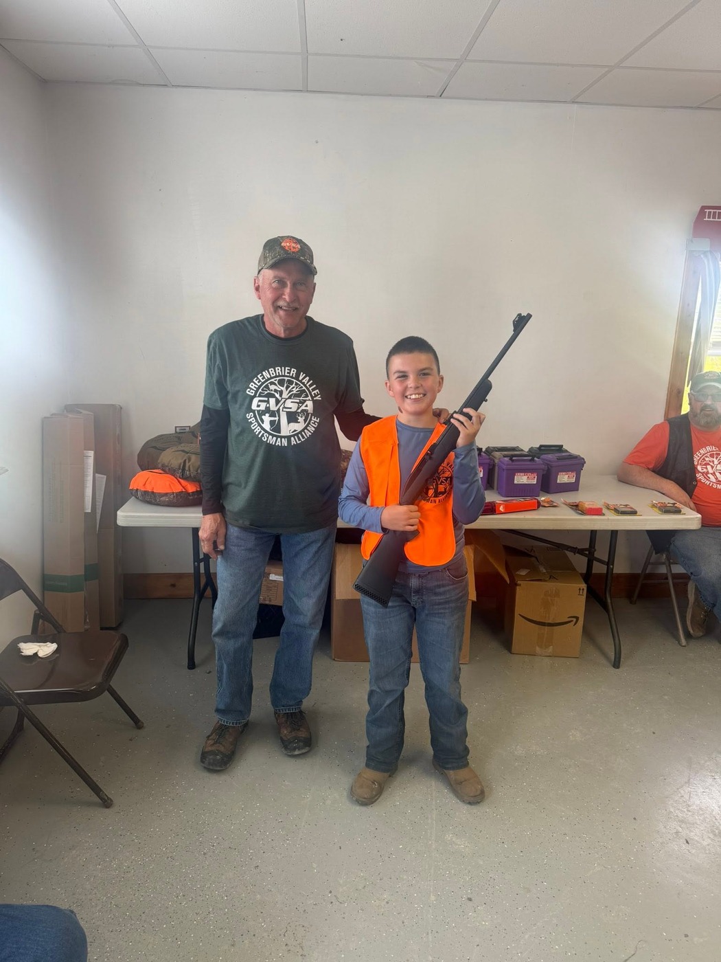 A young hunter with the rifle raffled off at the Youth Squirrel Hunt