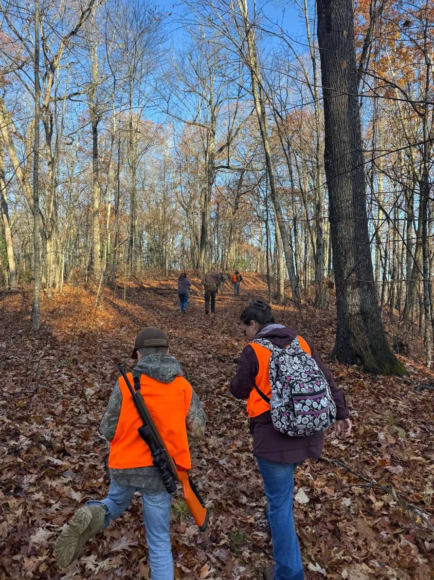 Youth hunters and a mentor heading into the woods for the Youth Squirrel Hunt